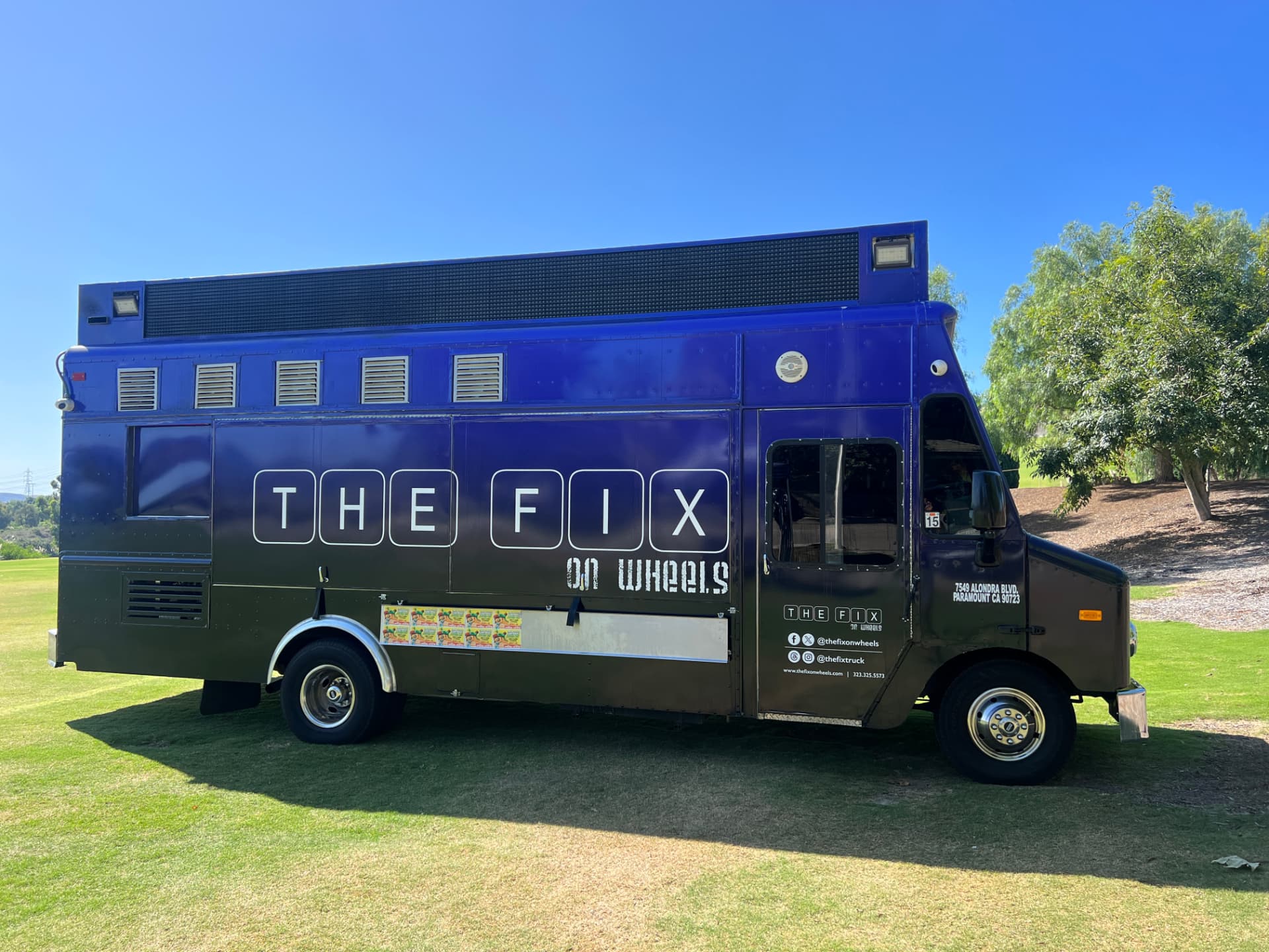 The Fix on Wheels food truck — full side view with the purple and black wrap