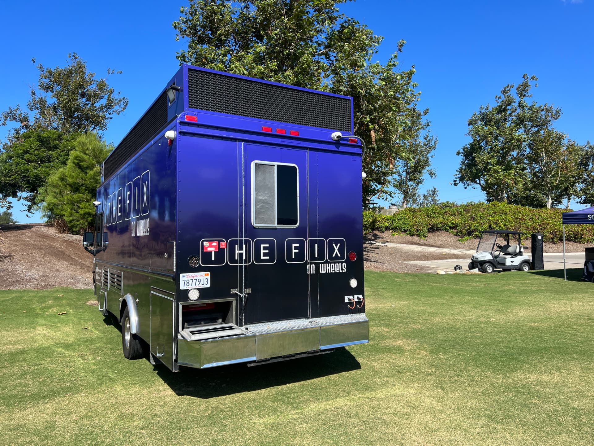 The Fix on Wheels truck from the rear, showing the purple wrap and branding